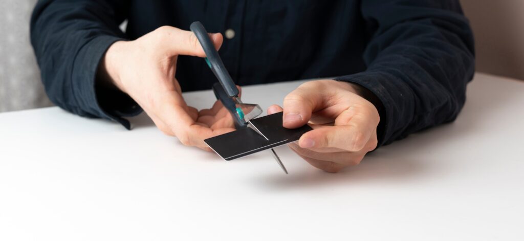 a person cut the credit card with scissors. problem of bunkrupt and money loss
