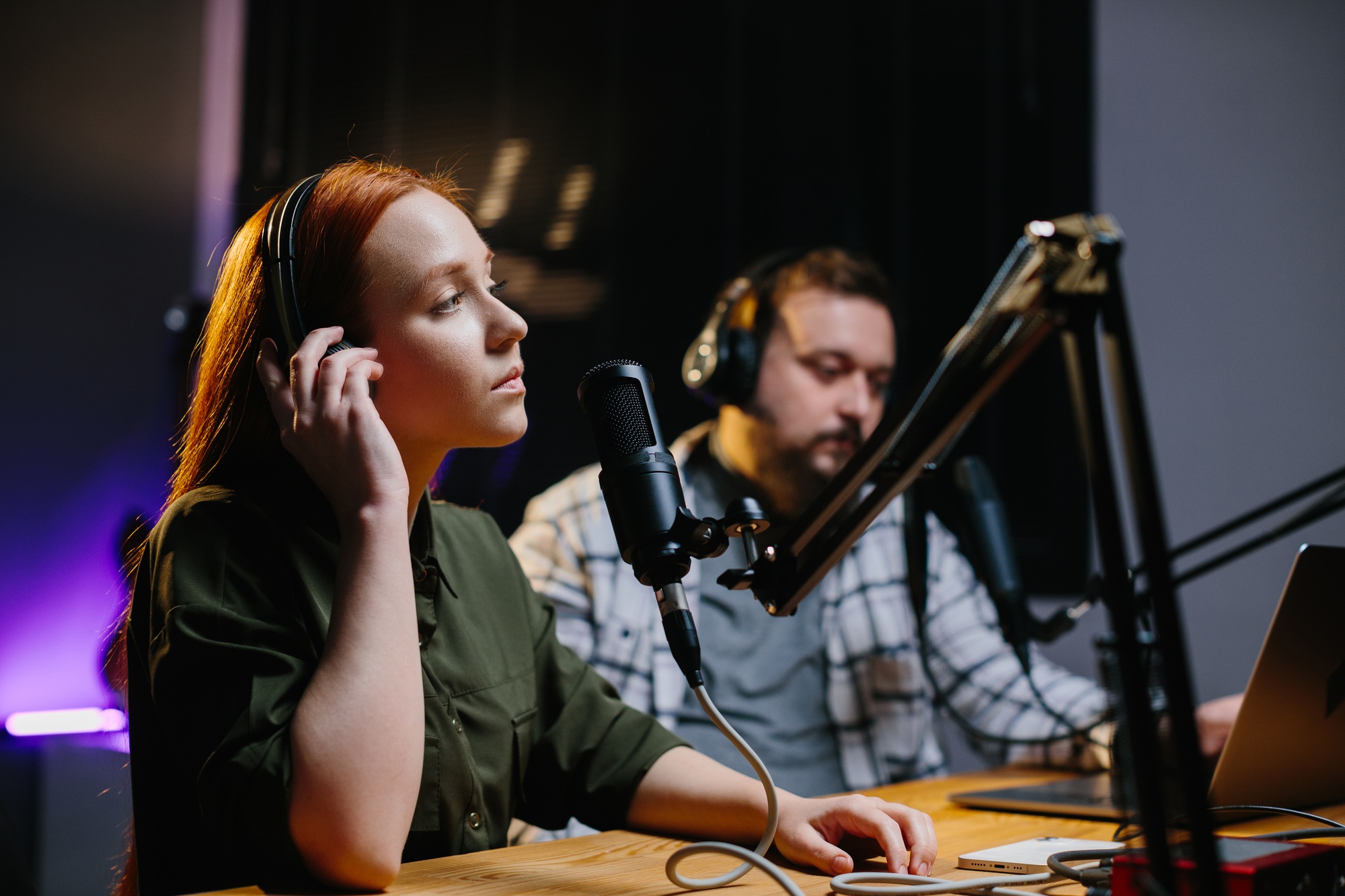 Presenters or moderators - man and woman - in radio station hosting show for radio live in Studio